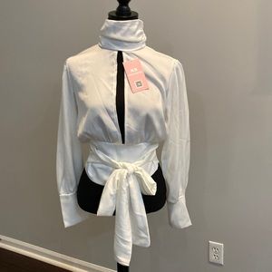 Cream Blouse slit front, open back. Brand new w Tags. Size Large